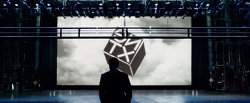 Movie still from “Steve Jobs” (2015), directed by Danny Boyle – A man standing in front of a projection screen; Extreme Wide shot, Low angle