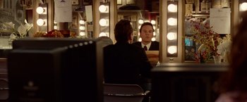 Movie still from “Steve Jobs” (2015), directed by Danny Boyle – A man sitting in front of a mirror in a dressing room; Medium shot, Over the shoulder angle