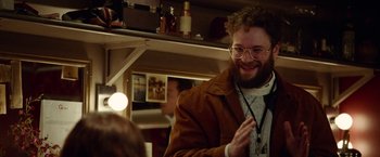 Movie still from “Steve Jobs” (2015), directed by Danny Boyle – A man with a beard wearing glasses and a brown jacket; Medium shot, Over the shoulder angle