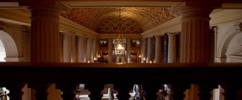 Movie still from “Steve Jobs” (2015), directed by Danny Boyle – A view of a room with a chandelier and pillars in it; Extreme Wide shot, Low angle