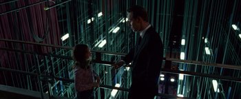 Movie still from “Steve Jobs” (2015), directed by Danny Boyle – A man and a woman talking in a dark room; Wide shot, Low angle