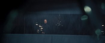 Movie still from “Steve Jobs” (2015), directed by Danny Boyle – A man standing in front of a window with lights; Wide shot, Low angle