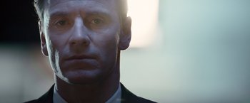 Movie still from “Steve Jobs” (2015), directed by Danny Boyle – A man in a suit looking into the distance; Close Up shot, Low angle