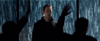Movie still from “Steve Jobs” (2015), directed by Danny Boyle – A man standing in front of a wall of water; Close Up shot, Over the shoulder angle