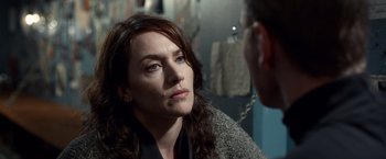 Movie still from “Steve Jobs” (2015), directed by Danny Boyle – A woman looking at a man in a room; Close Up shot, Over the shoulder angle