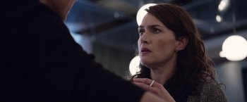 Movie still from “Steve Jobs” (2015), directed by Danny Boyle – A woman looking at a man in front of a mirror; Close Up shot, Over the shoulder angle