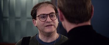 Movie still from “Steve Jobs” (2015), directed by Danny Boyle – A man wearing glasses talking to another man; Close Up shot, Over the shoulder angle