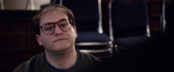 Movie still from “Steve Jobs” (2015), directed by Danny Boyle – A person wearing glasses; Close Up shot, Over the shoulder angle