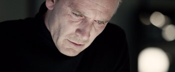 Movie still from “Steve Jobs” (2015), directed by Danny Boyle – An older man looking down at his face; Close Up shot, Low angle