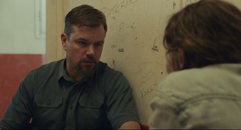 Movie still from “Stillwater” (2021), directed by Tom McCarthy – A man sitting in front of a wall talking to a woman; Close Up shot, Over the shoulder angle