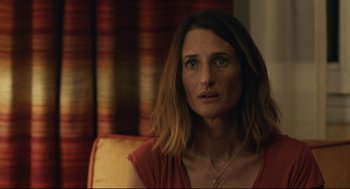 Movie still from “Stillwater” (2021), directed by Tom McCarthy – A person sitting in a chair; Close Up shot, Over the shoulder angle