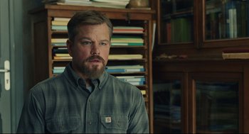 Movie still from “Stillwater” (2021), directed by Tom McCarthy – A person with a beard in a room; Close Up shot, Over the shoulder angle