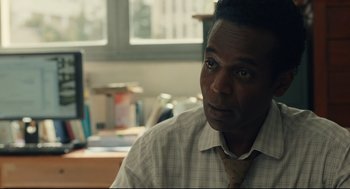 Movie still from “Stillwater” (2021), directed by Tom McCarthy – A person wearing a shirt and a tie; Close Up shot, Over the shoulder angle