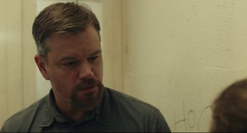 Movie still from “Stillwater” (2021), directed by Tom McCarthy – A person with a beard; Close Up shot, Over the shoulder angle