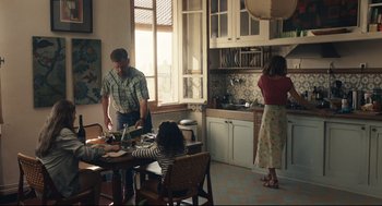 Movie still from “Stillwater” (2021), directed by Tom McCarthy – Three people in a kitchen preparing a meal together; Wide shot, Over the shoulder angle