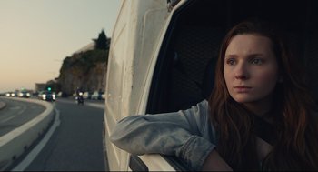 Movie still from “Stillwater” (2021), directed by Tom McCarthy – A woman leaning out of the window of a truck; Close Up shot, Low angle