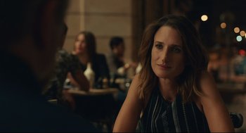 Movie still from “Stillwater” (2021), directed by Tom McCarthy – A woman sitting in front of a group of people in a room; Close Up shot, Over the shoulder angle