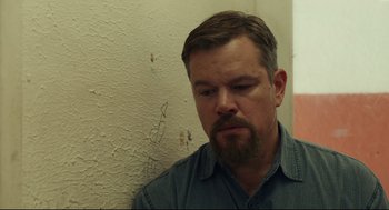 Movie still from “Stillwater” (2021), directed by Tom McCarthy – A person with a beard; Close Up shot, Over the shoulder angle