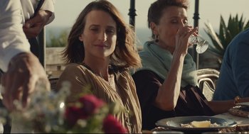 Movie still from “Stillwater” (2021), directed by Tom McCarthy – Two women sitting at a table with plates of food in front of them; Medium shot, Over the shoulder angle