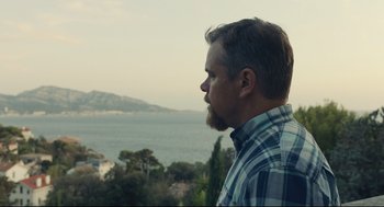 Movie still from “Stillwater” (2021), directed by Tom McCarthy – A man with a beard is looking out at the ocean; Close Up shot, Low angle