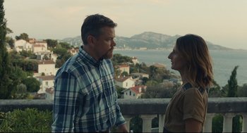 Movie still from “Stillwater” (2021), directed by Tom McCarthy – A man and a woman standing next to each other on a balcony; Medium shot, Over the shoulder angle