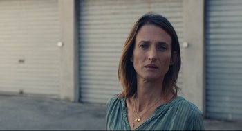 Movie still from “Stillwater” (2021), directed by Tom McCarthy – A person wearing a blue shirt; Close Up shot, Low angle