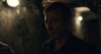 Movie still from “Stillwater” (2021), directed by Tom McCarthy – A person in a dark room; Close Up shot, Over the shoulder angle