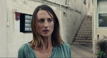 Movie still from “Stillwater” (2021), directed by Tom McCarthy – A person wearing a green shirt; Close Up shot, Over the shoulder angle