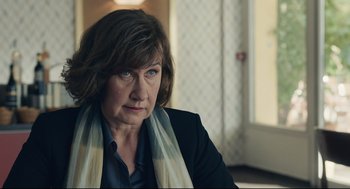 Movie still from “Stillwater” (2021), directed by Tom McCarthy – A person wearing a jacket and a scarf; Close Up shot, Over the shoulder angle