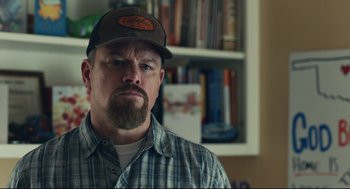 Movie still from “Stillwater” (2021), directed by Tom McCarthy – A person wearing a hat; Close Up shot, Low angle