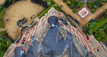 Movie still from “Belfast” (2021), directed by Kenneth Branagh – An aerial view of a building with a clock tower on it; Extreme Wide shot, Overhead angle