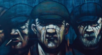 Movie still from “Belfast” (2021), directed by Kenneth Branagh – A painting of a man wearing a hat; Extreme Close Up shot, Low angle