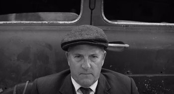 Movie still from “Belfast” (2021), directed by Kenneth Branagh – An older man in a suit and a hat; Close Up shot, Low angle