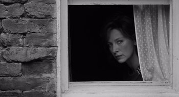 Movie still from “Belfast” (2021), directed by Kenneth Branagh – Black and white photograph of a woman looking out of a window; Close Up shot, Low angle