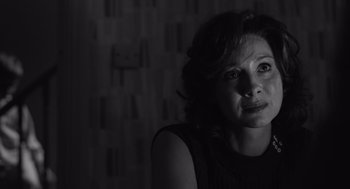 Movie still from “Belfast” (2021), directed by Kenneth Branagh – A black - and - white photo of a woman looking at the camera; Close Up shot, Over the shoulder angle