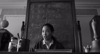 Movie still from “Belfast” (2021), directed by Kenneth Branagh – A woman standing in front of a chalkboard; Close Up shot, Low angle
