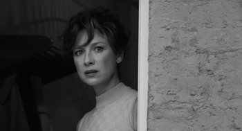 Movie still from “Belfast” (2021), directed by Kenneth Branagh – Black and white photograph of a woman looking out of a window; Close Up shot, Low angle