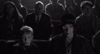 Movie still from “Belfast” (2021), directed by Kenneth Branagh – An older woman and a young boy in a theater; Close Up shot, Over the shoulder angle