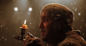 Movie still from “Belfast” (2021), directed by Kenneth Branagh – An old man holding a lit candle in his hand; Extreme Close Up shot, Low angle
