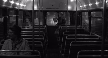Movie still from “Belfast” (2021), directed by Kenneth Branagh – A black and white photo of a person on a bus; Wide shot, Over the shoulder angle
