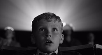 Movie still from “Belfast” (2021), directed by Kenneth Branagh – A young boy looking up into the sky; Close Up shot, Low angle