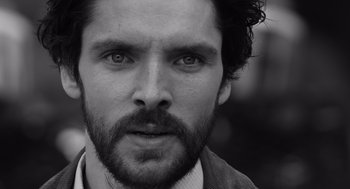 Movie still from “Belfast” (2021), directed by Kenneth Branagh – Black and white photograph of a man with a beard; Extreme Close Up shot, Over the shoulder angle