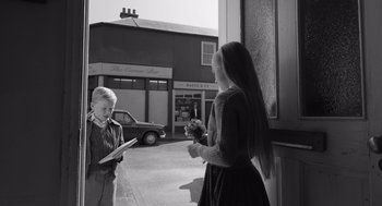 Movie still from “Belfast” (2021), directed by Kenneth Branagh – A boy and a girl standing on the sidewalk; Medium shot, Over the shoulder angle