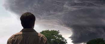 Movie still from “Take Shelter” (2011), directed by Jeff Nichols – A man standing in front of a storm cloud; Medium shot, Low angle