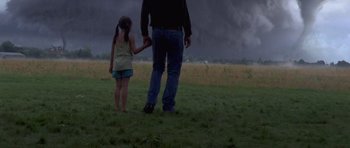 Movie still from “Take Shelter” (2011), directed by Jeff Nichols – A man and a girl holding hands in a field; Wide shot, Low angle