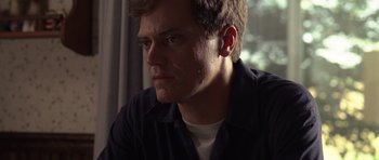 Movie still from “Take Shelter” (2011), directed by Jeff Nichols – A person sitting in front of a window; Close Up shot, Low angle