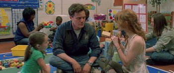 Movie still from “Take Shelter” (2011), directed by Jeff Nichols – A man and a woman sitting on the ground; Medium shot, Over the shoulder angle