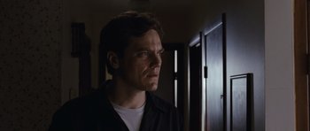 Movie still from “Take Shelter” (2011), directed by Jeff Nichols – A person wearing a black shirt; Close Up shot, Low angle