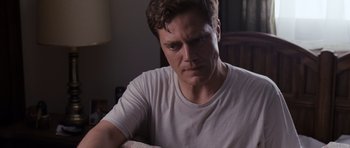 Movie still from “Take Shelter” (2011), directed by Jeff Nichols – A person wearing a white t - shirt; Close Up shot, Over the shoulder angle