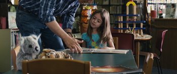 Movie still from “Take Shelter” (2011), directed by Jeff Nichols – A man helping a little girl with a book; Medium shot, Over the shoulder angle